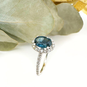 Blue Hued Teal Sapphire and Diamond Halo and Band White Gold Ring Wedding Set