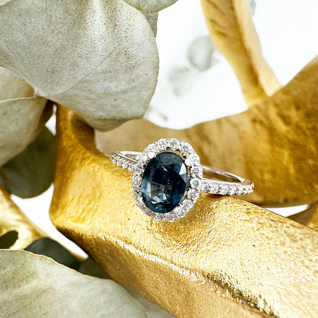 Blue Hued Teal Sapphire and Diamond Halo and Band White Gold Ring Wedding Set