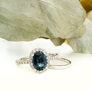 Blue Hued Teal Sapphire and Diamond Halo and Band White Gold Ring Wedding Set