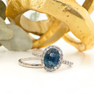 Blue Hued Teal Sapphire and Diamond Halo and Band White Gold Ring Wedding Set