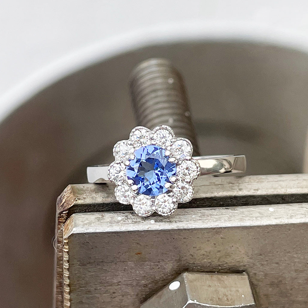 Floral tanzanite and diamond halo ring