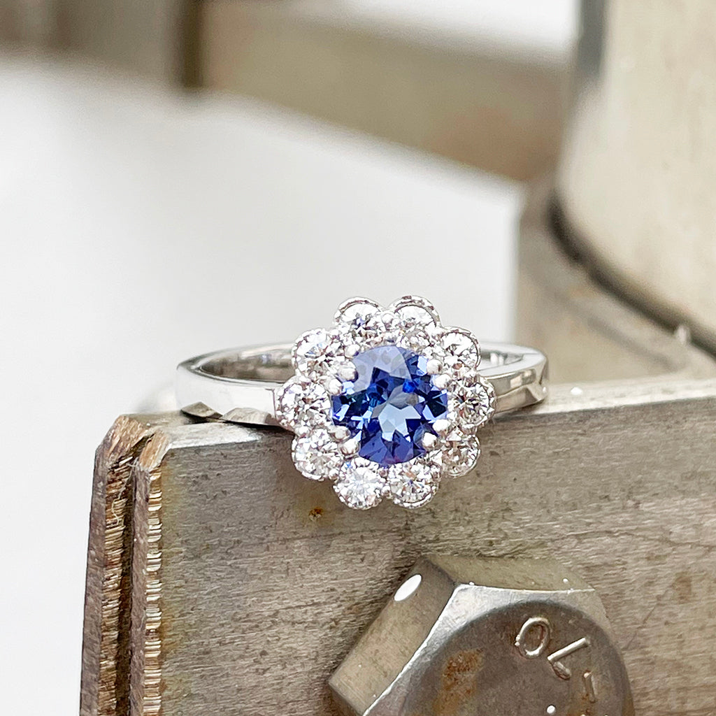 Floral tanzanite and diamond halo ring