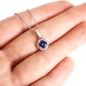 Elevated Tanzanite and Diamond Halo Pendant in White Gold
