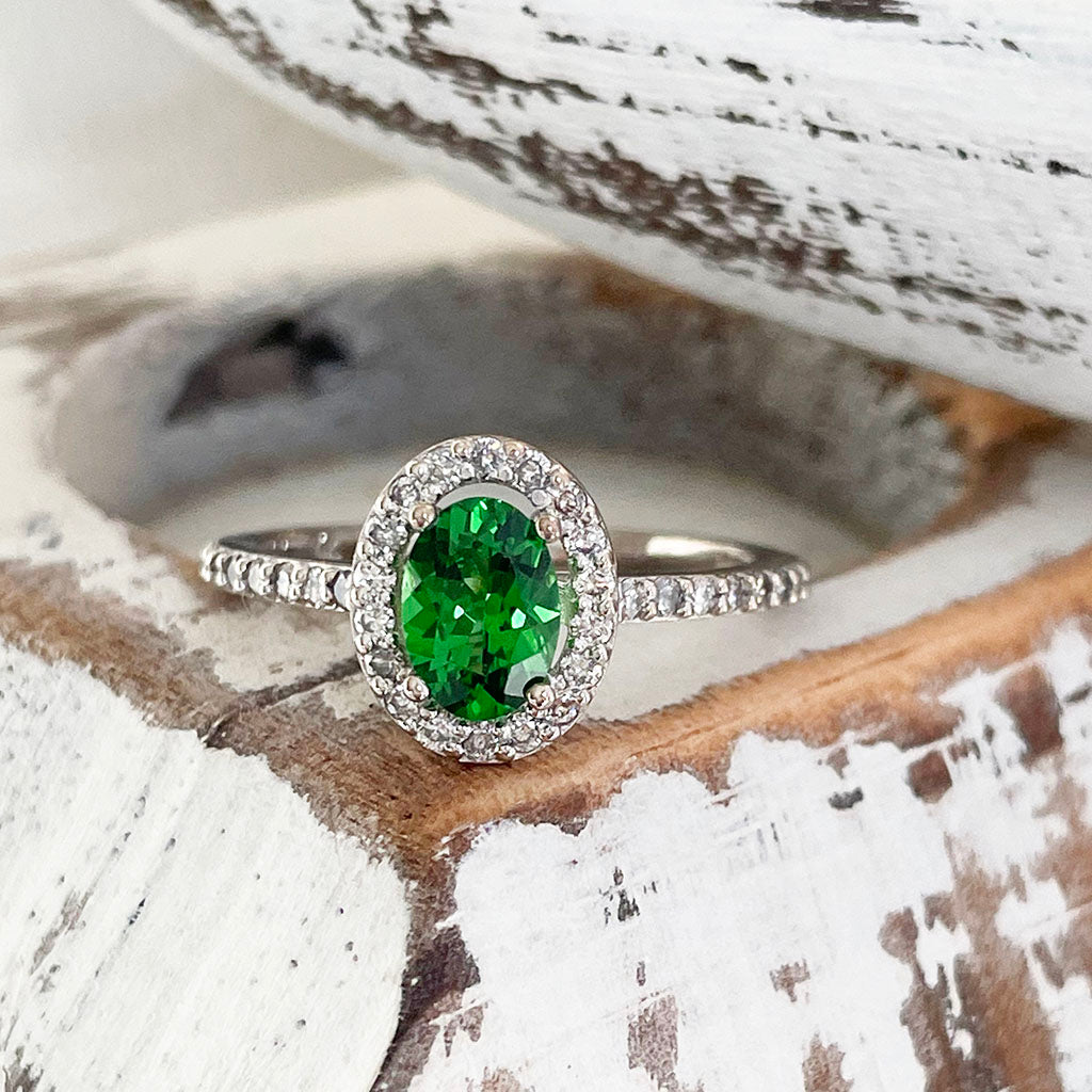 Tsavorite and diamond halo white gold ring