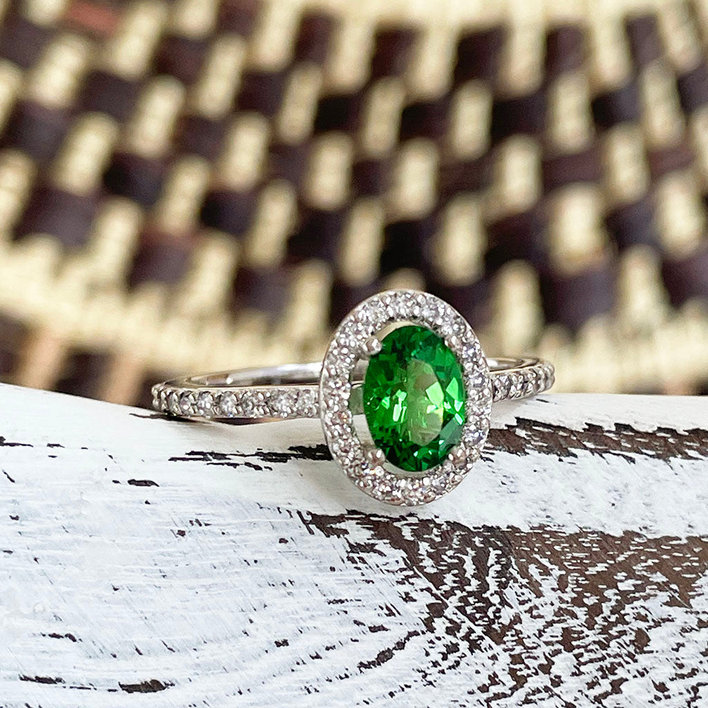 Tsavorite and diamond halo white gold ring