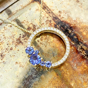 Tanzanite and diamond halo pendant