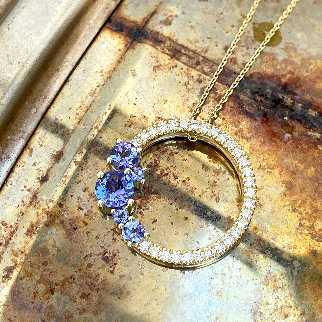 Tanzanite and diamond halo pendant