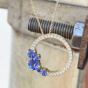 Tanzanite and diamond halo pendant