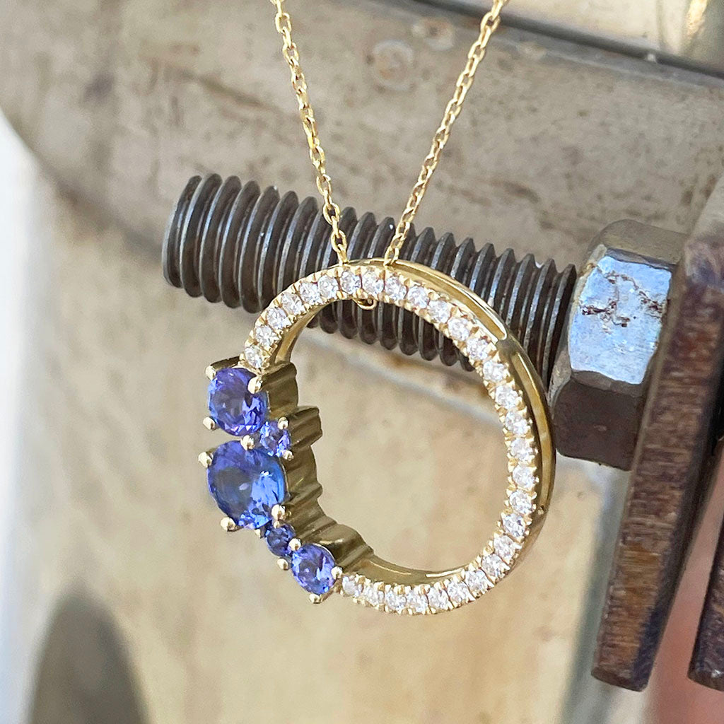  Tanzanite and diamond halo pendant